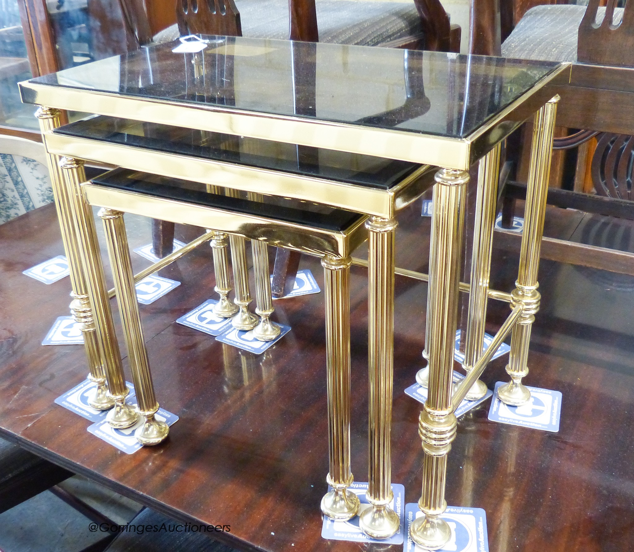 Two nests of gilt metal and glass tables and a similar coffee table.